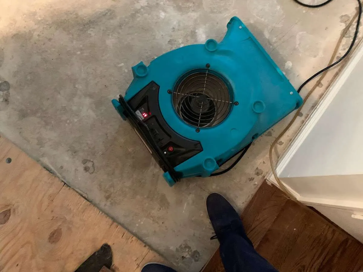 Air mover drying subfloor during Leak Detection & Repair in Borger